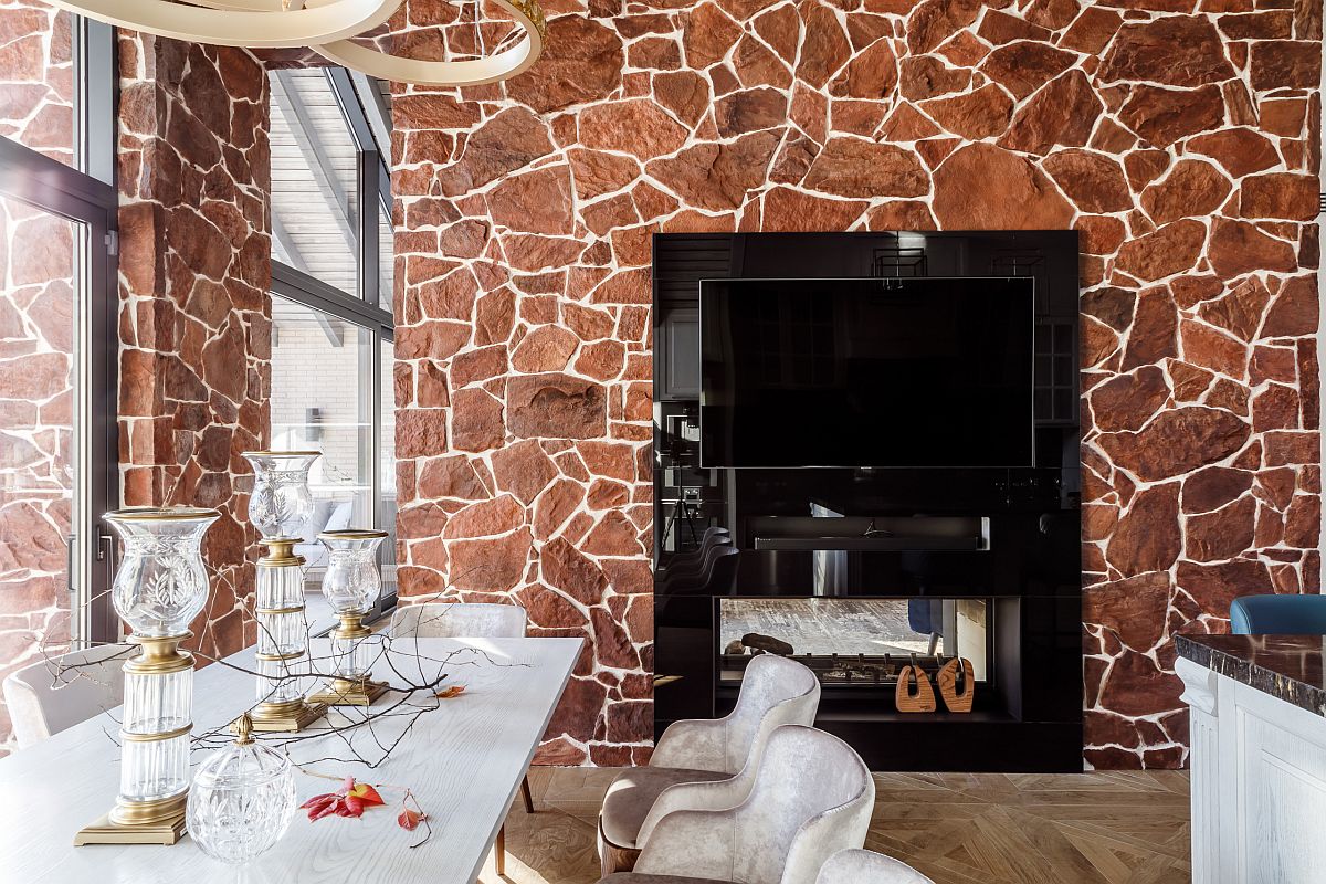 Gorgeous two-sided fireplace fits into the wall beautifully while illuminating both the kitchen and dining space