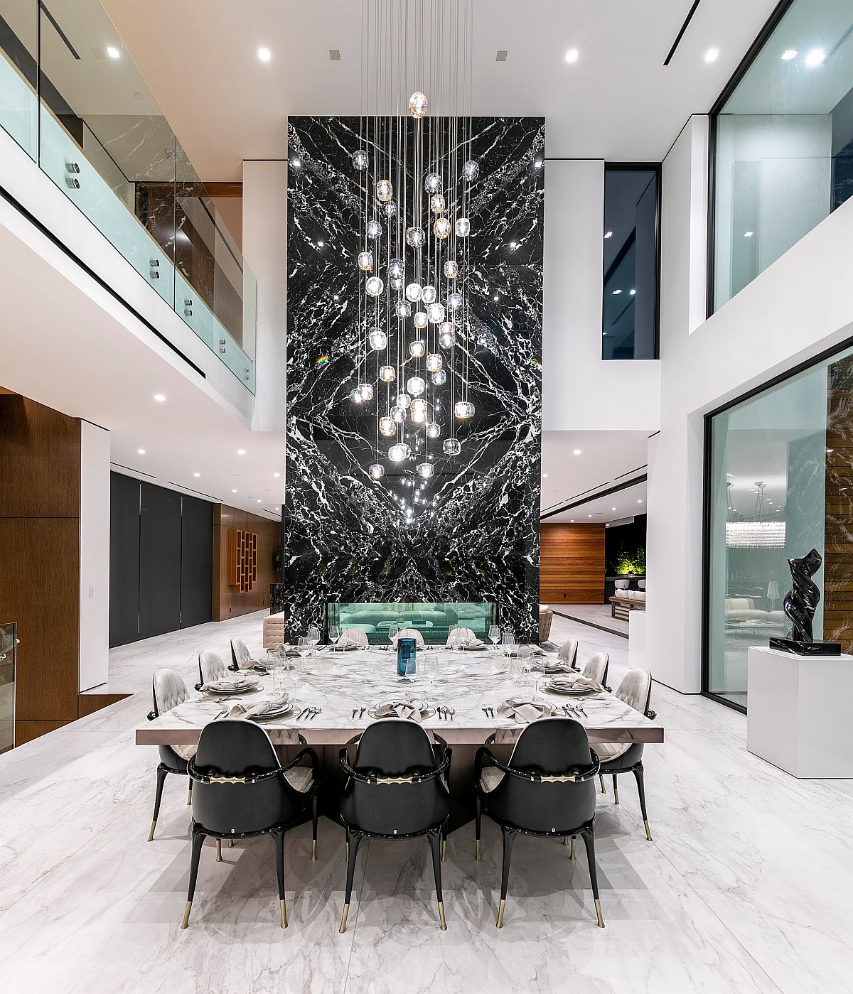 Mesmerizing marble fireplae coupled with stunning chandelier in the dining space