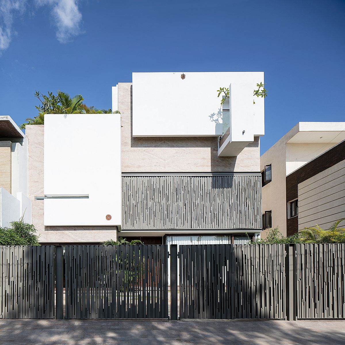 Perforated metal sheet provides privacy while allowing for filtered light to enter the home