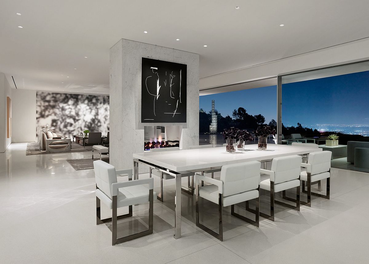 Polished contemporary dining room of LA home with spectacular views and a double-sided fireplace