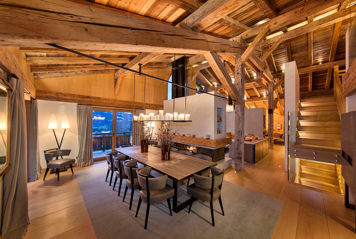 Rustic style dining room for Chalet-style home with a lovely two-sided fireplace