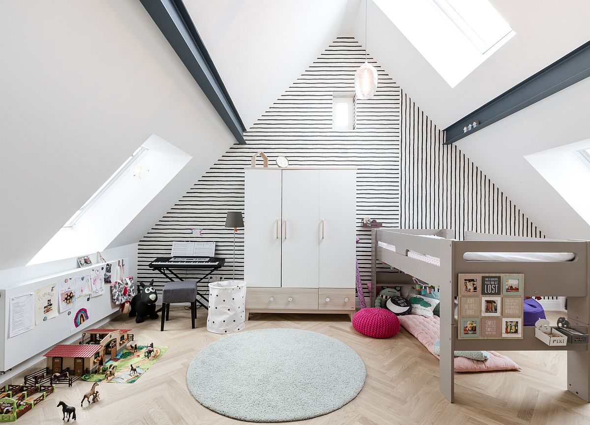 Simple black and white wallpaper with fun stripes add pattern to this attic kids' room without altering the color scheme