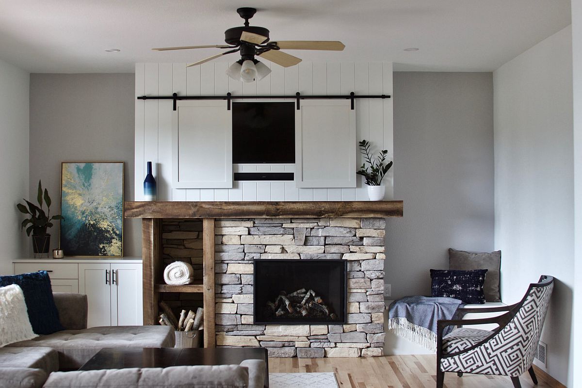 Sliding wooden panes conceal the television in this farmhouse style living space elegantly