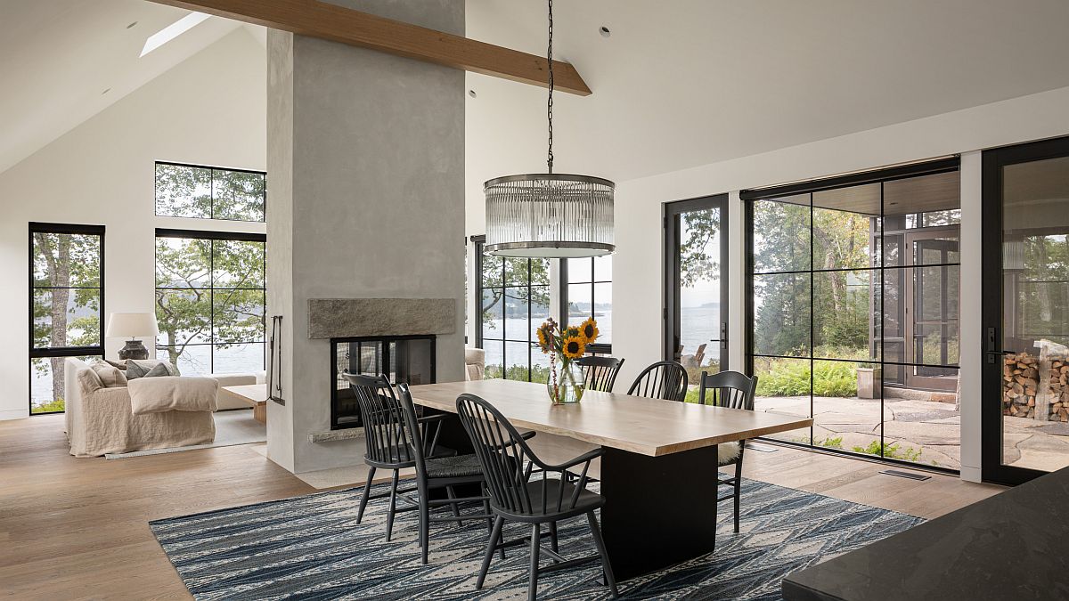 Spacious and elegant beach style dining room with lovely ambiance and a double-sided fireplace