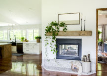 floating wooden beam mantel against white wall