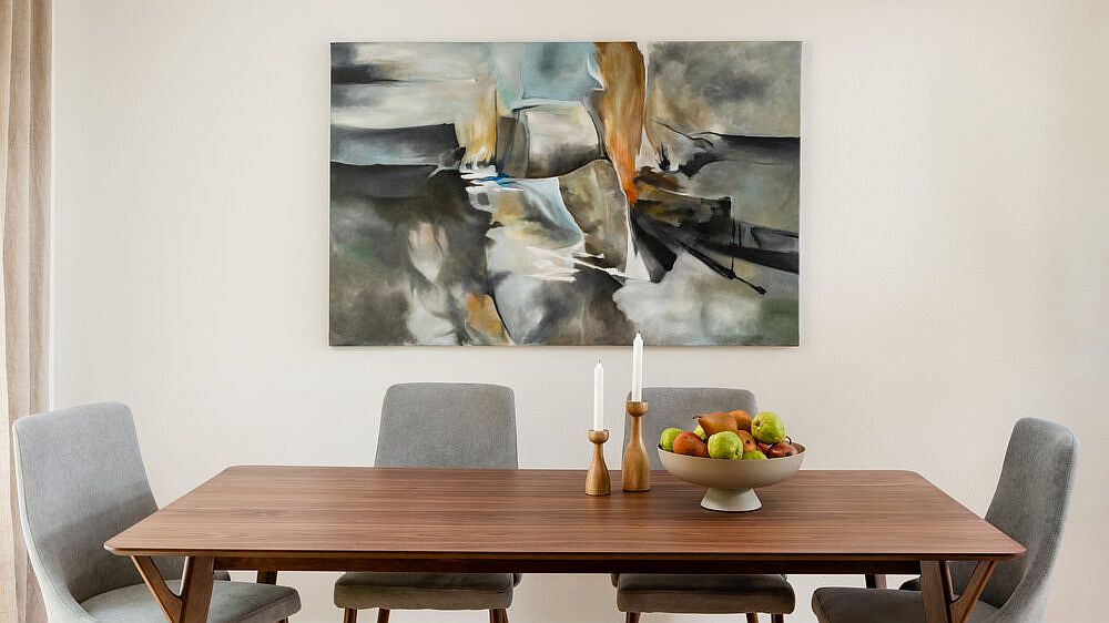 Wall art steals the show in this modern dining room with neutral colors
