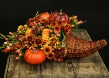 a cornucopia filled with flowers and fall accessories