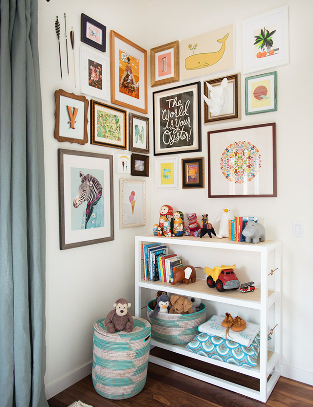 a corner gallery wall display in a child's bedroom