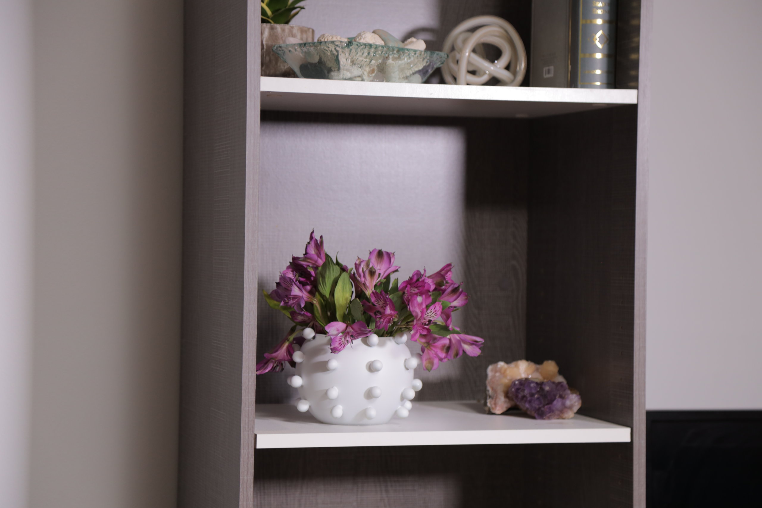 modern marble vase with flowers on shelf