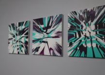 three completed spin art canvases hanging