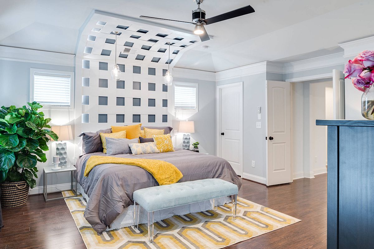 Bedding is used to add yellow and gray to the modern neutral bedroom along with the smart rug