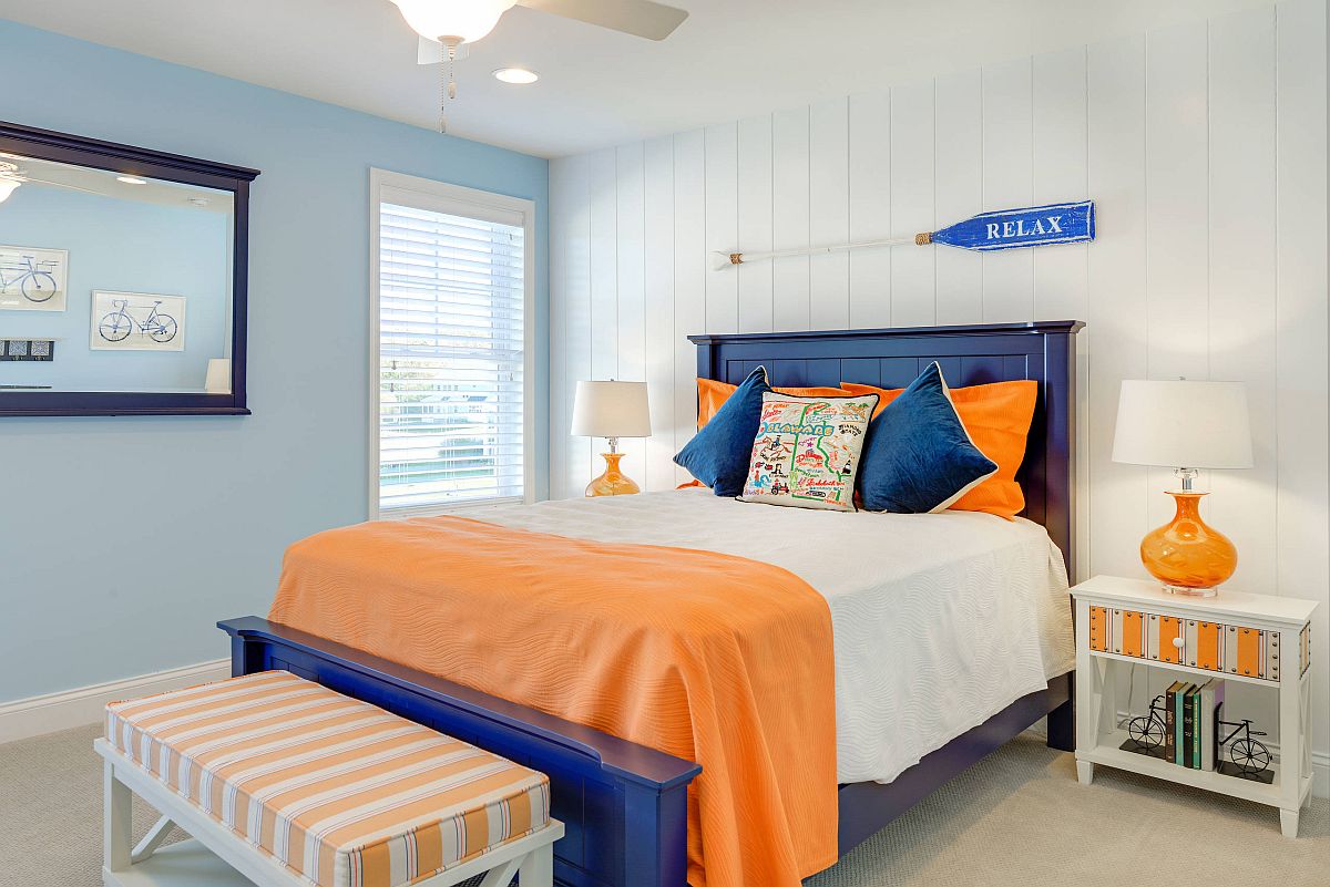 Blue and orange accents added to the neutral bedroom to usher in nautical style