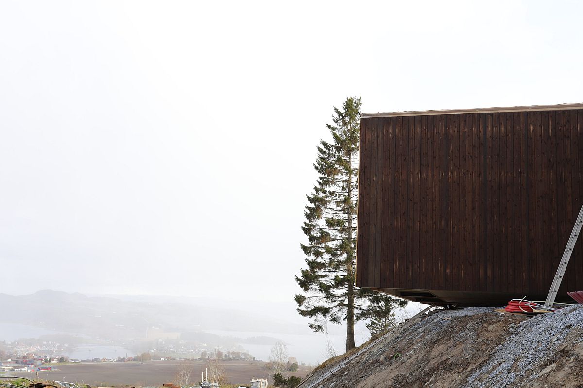 Cabin-style wooden units have been anchored to the ground even as the overlook distant landscape