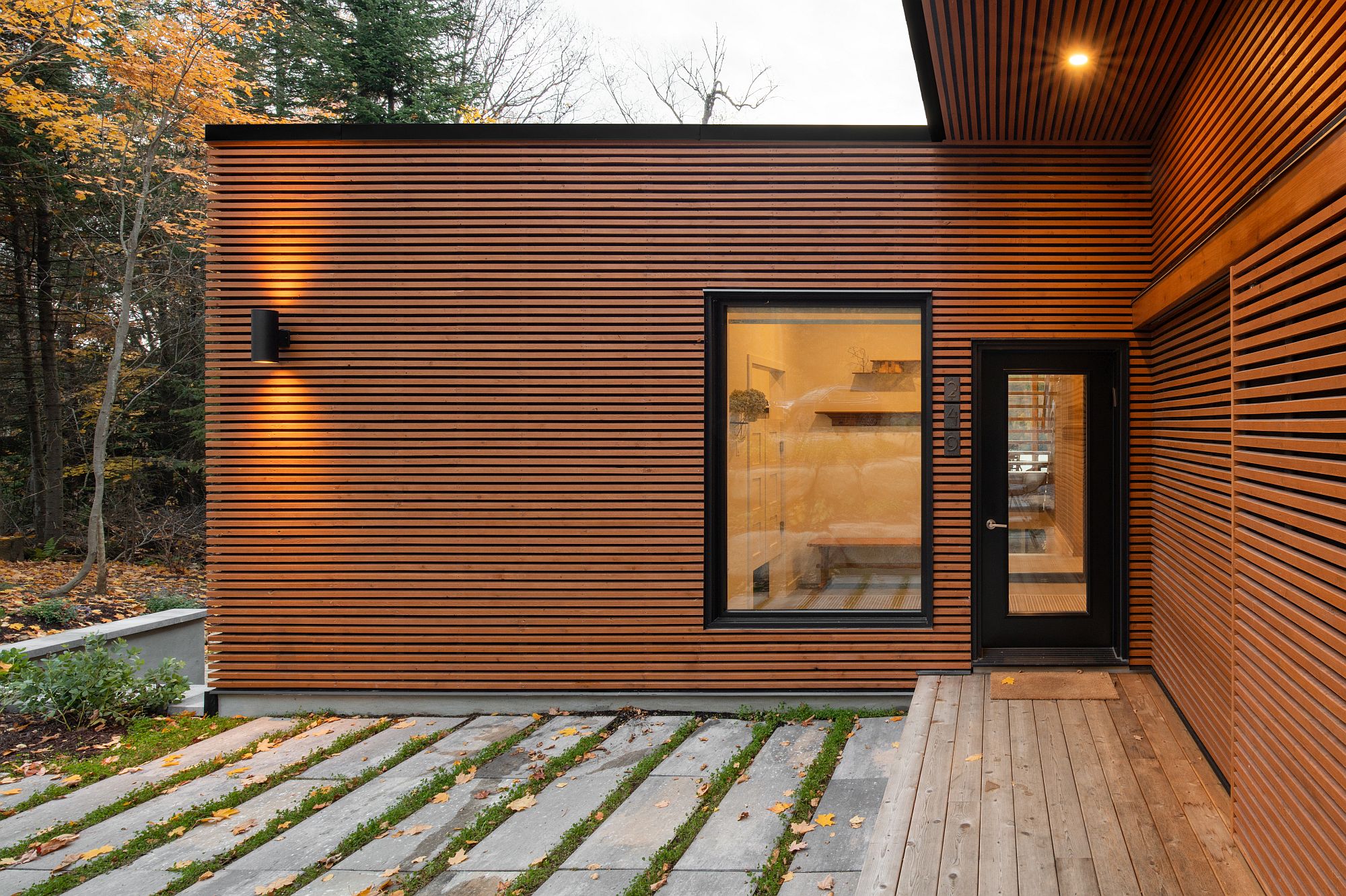 Charming exterior of the home with natural-looking finish combined with dark trims