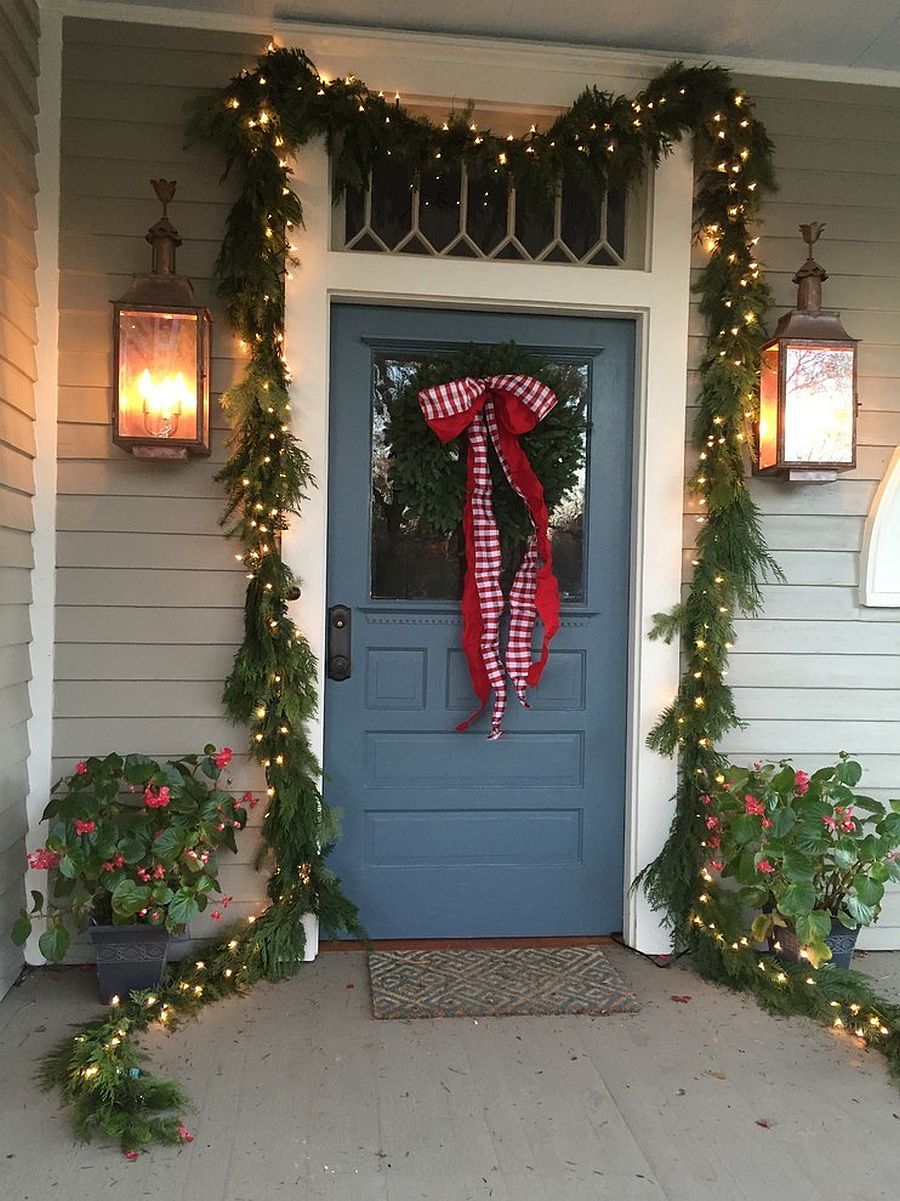 Combine the lush green garland with string lighting for a smart entryway that feels cheerful