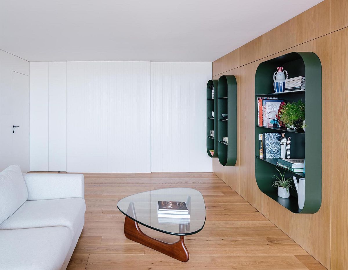 Cozy wooden walls accentuate the appeal of the metallic green shelves