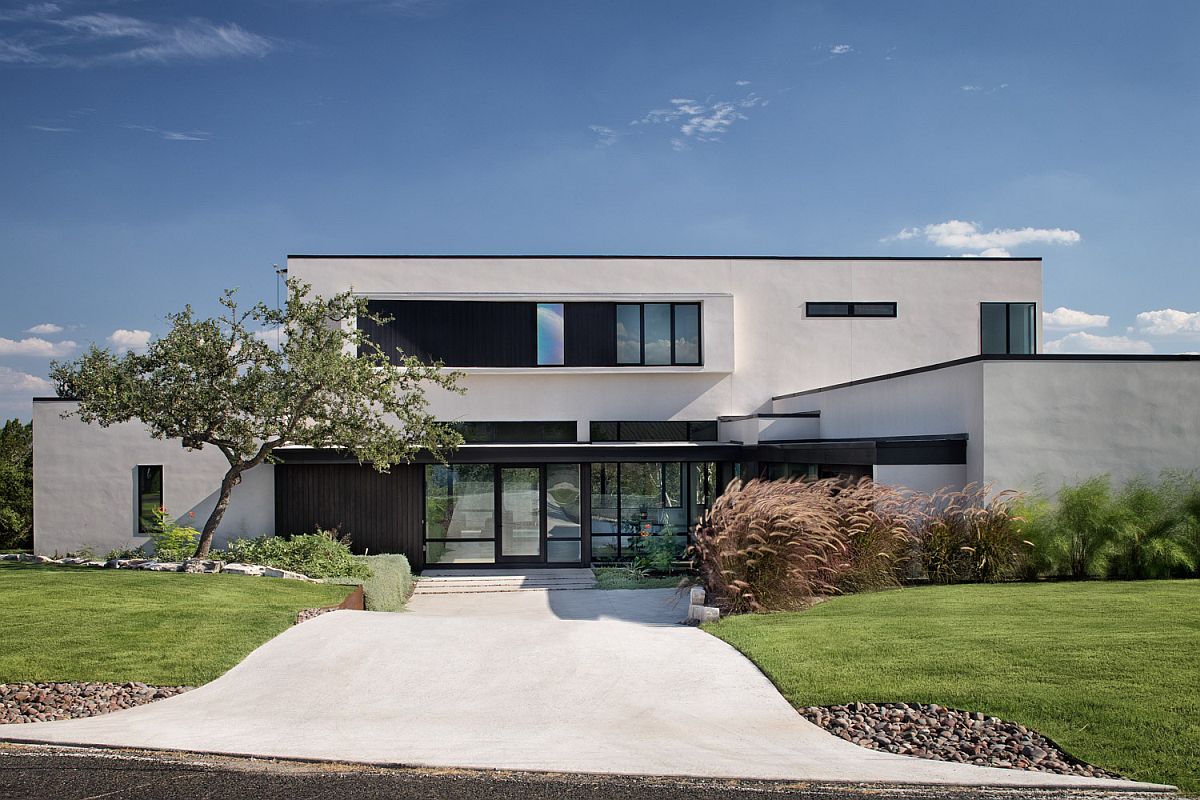 Dark and dashing framed entry of the home in white and glass is a showstopper