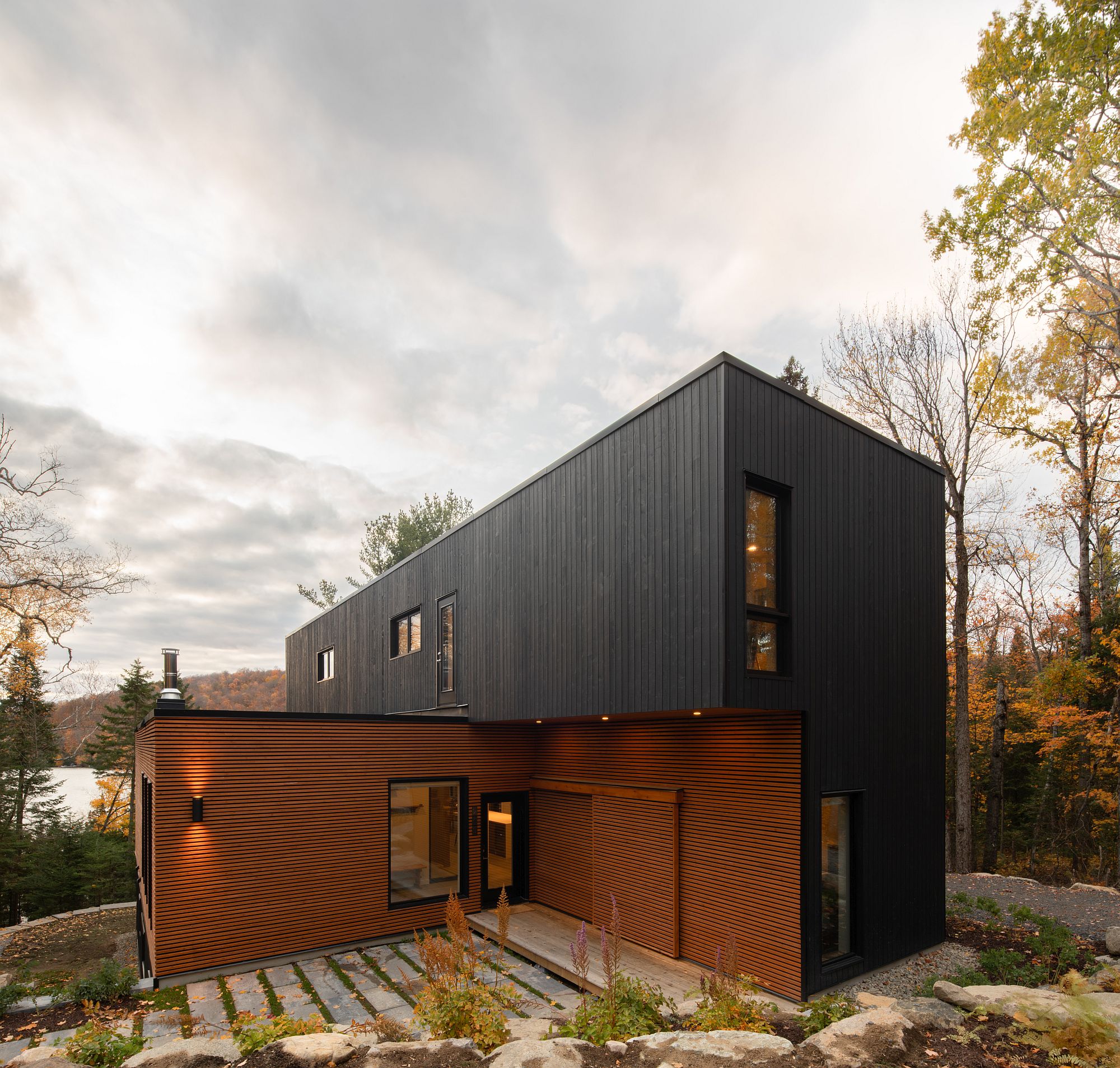 Dark upper level of the home stands in contrast to the natural lower level exterior finish