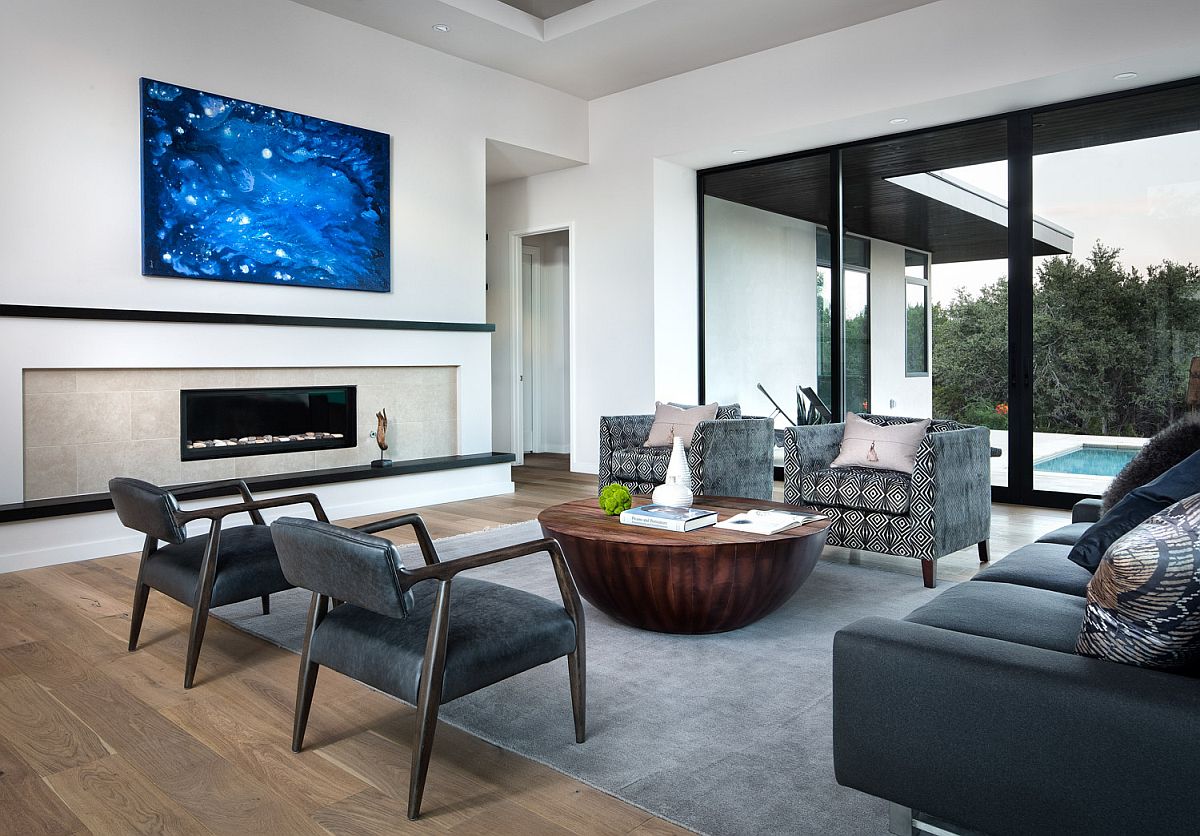 Dashing slim fireplace is at the heart of this living area connected with the pool and courtyard