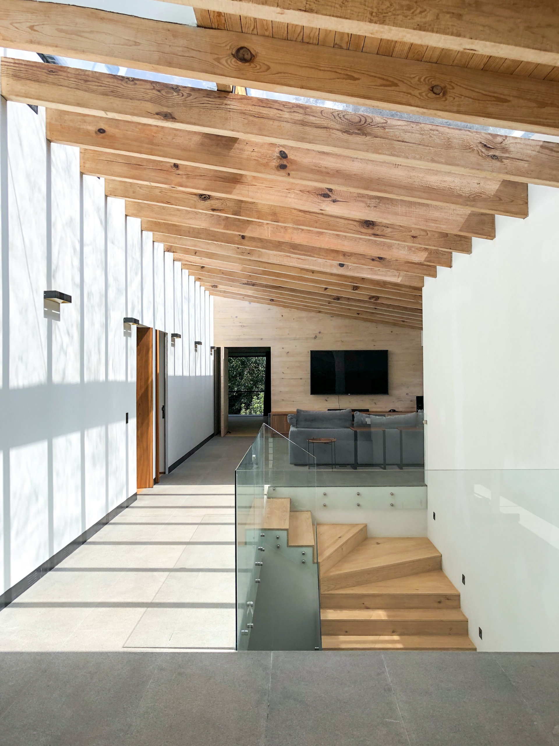 Interior of the expansive green home in Valle de Bravo draped in wood, white and glass