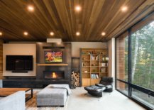 Living-area-of-the-house-with-a-smart-fireplace-woodsy-ceiling-and-large-floor-to-ceiling-glass-walls-that-bring-the-outdoors-inside-86724-217x155