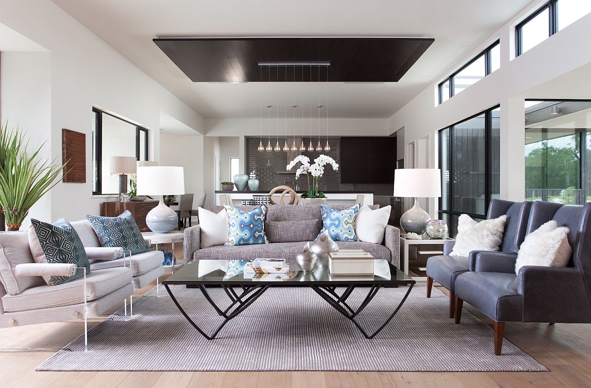 Luxurious open plan living area with neutral color scheme and simple blue accents