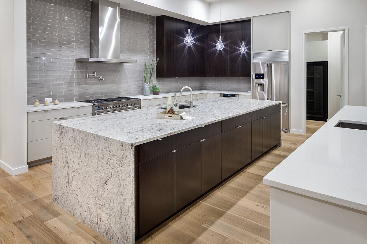 Modern kitchen with stone island, Edison bulb lighting and a striking gray backsplash