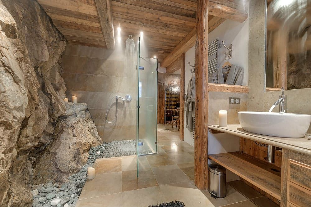 Natural rock becomes a part of the bathroom at this gorgeous alpine chalet