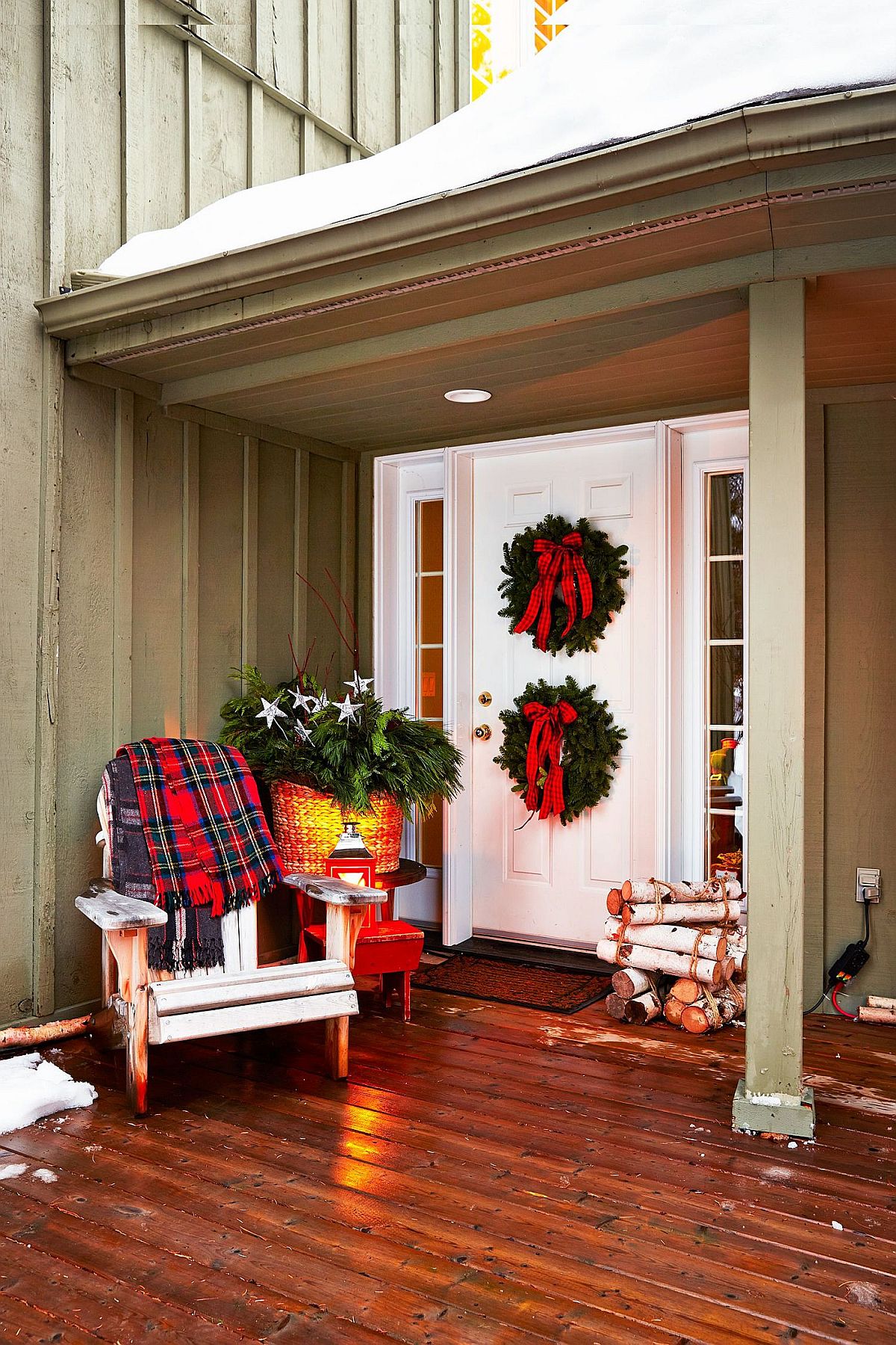 Plaid pattern, holiday wreath and greenery used to decorate the festive porch