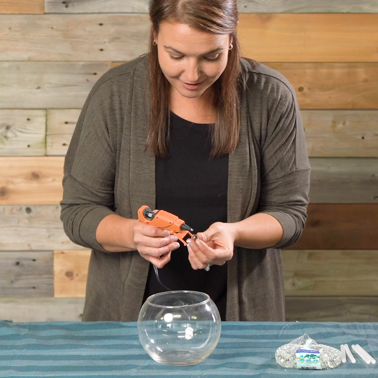 gluing marbles onto vase for modern diy vase