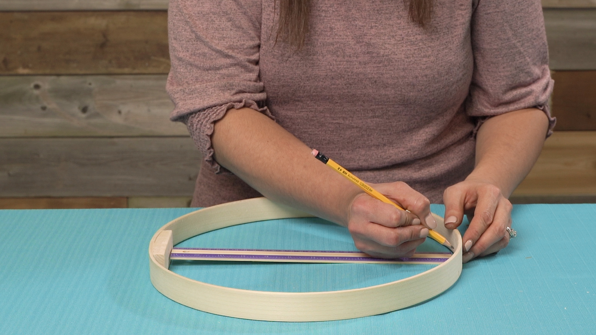 using ruler to mark center point on embroidery hoop