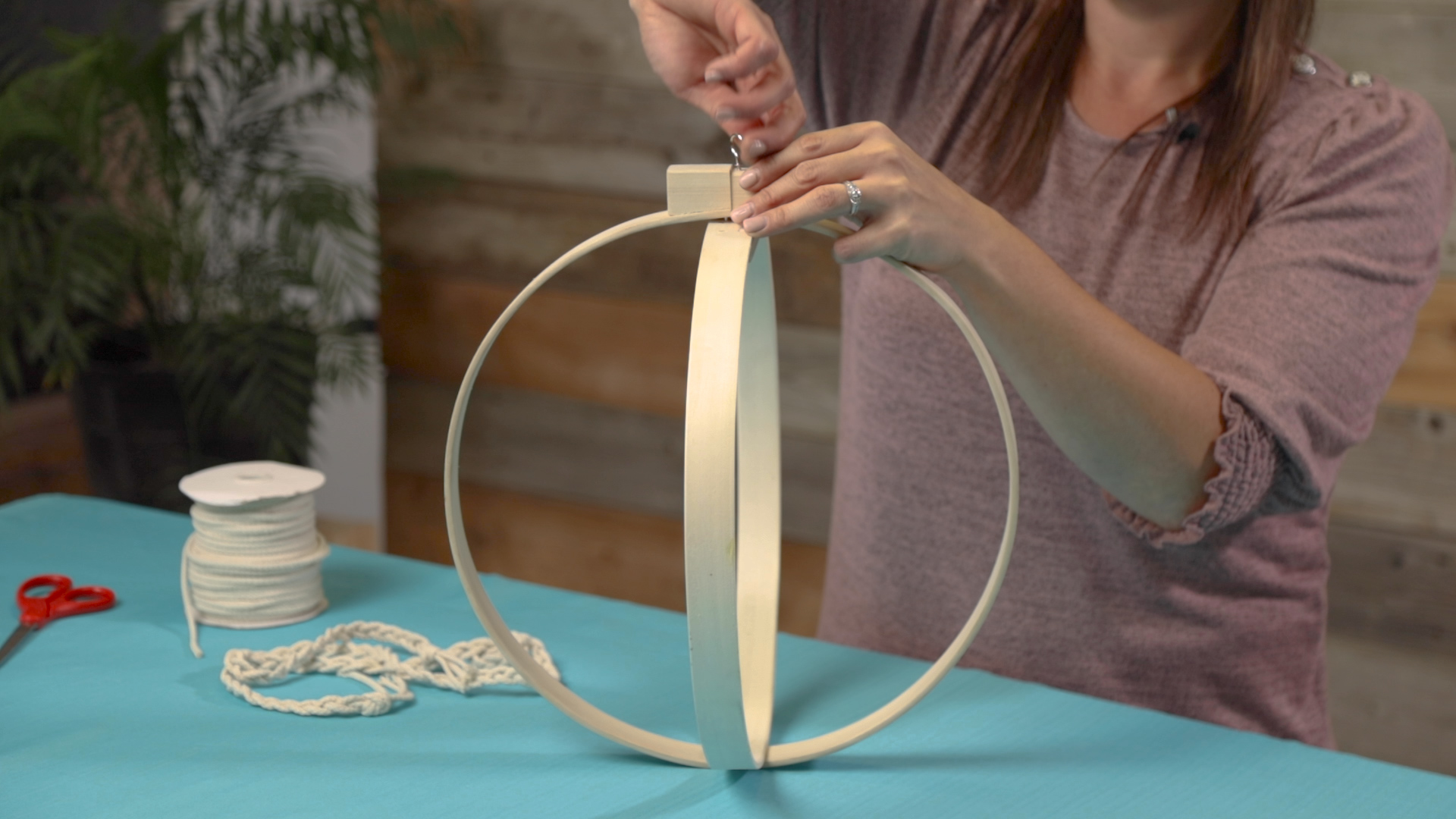 inserting hook into embroidery hoop for boho planter