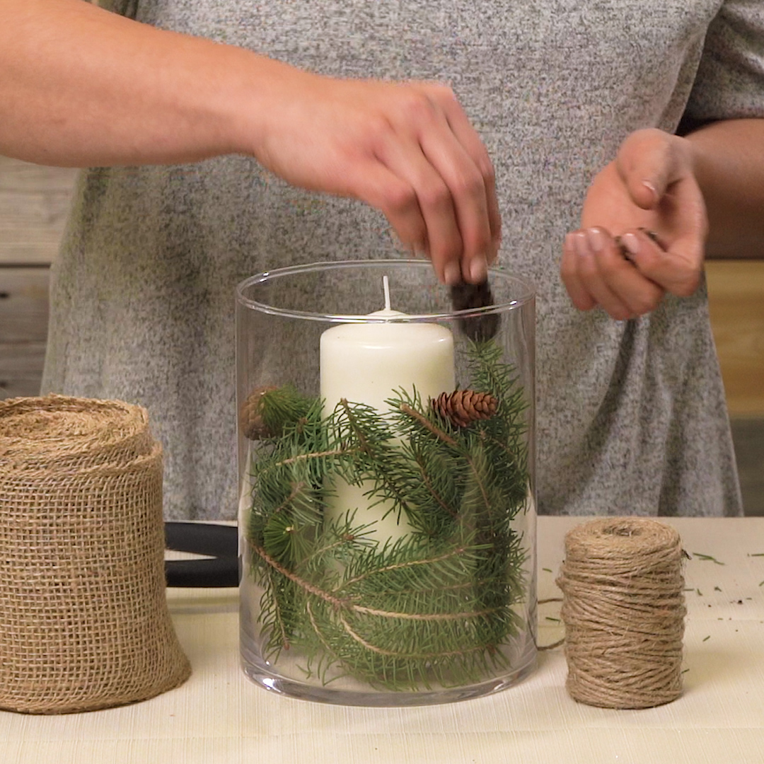 adding mini pinecones to winter centerpiece
