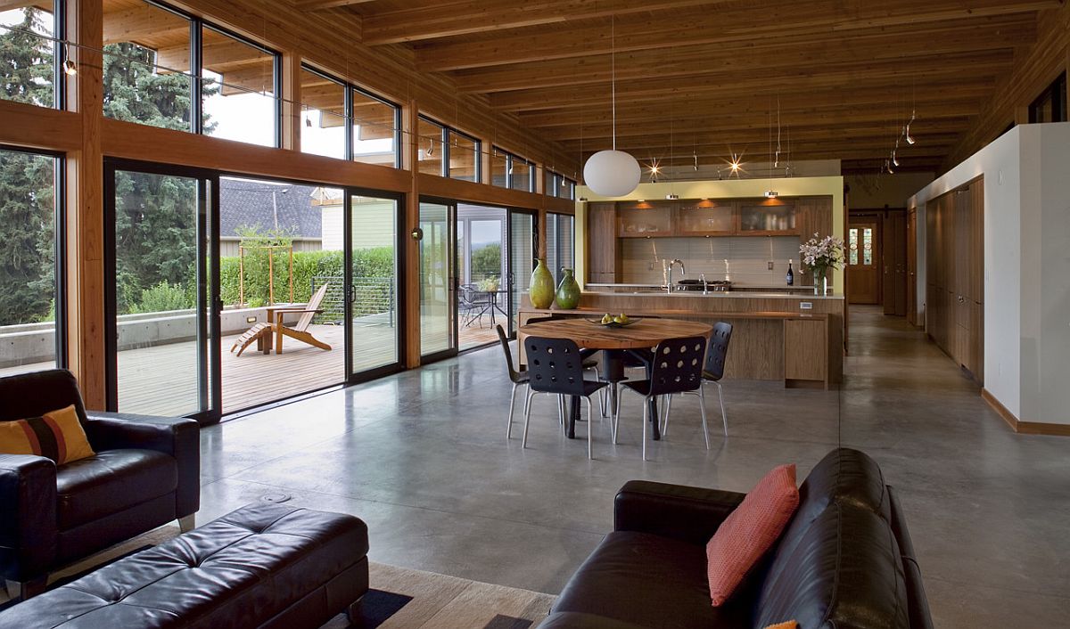 Spacious and open plan living space of the Vancouver home with a sloping roof and glass walls