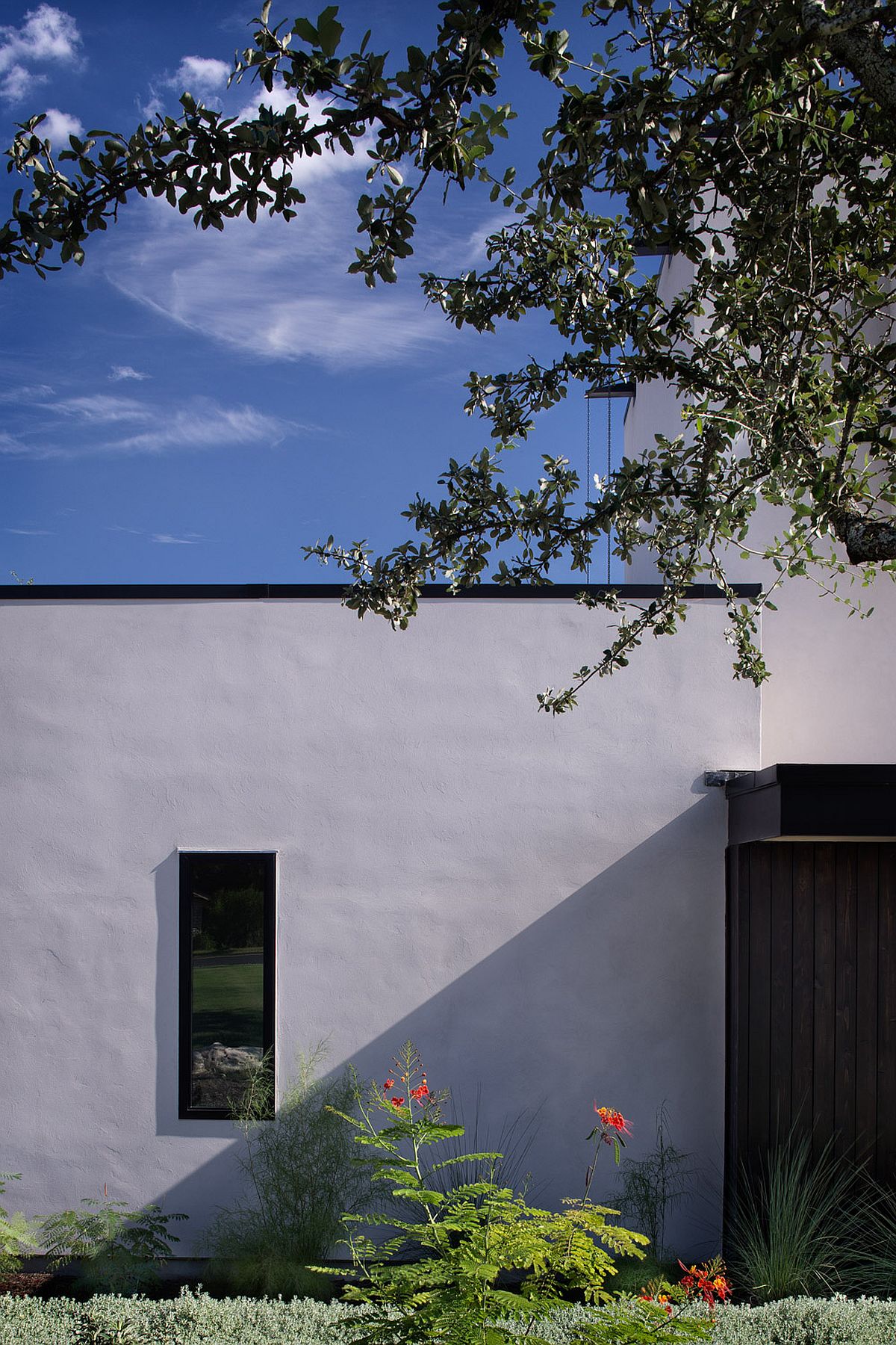 View of the private street facade of the contemporary Texas home