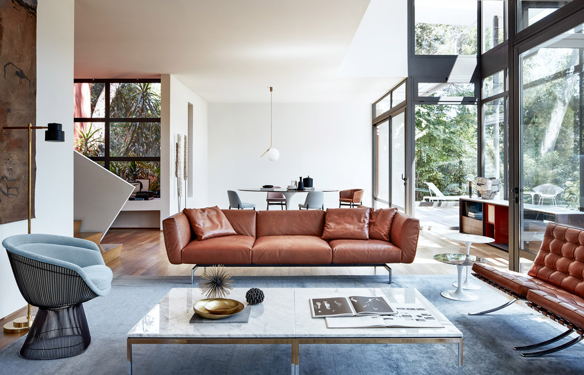 living room with marble table, metal chair, and leather couches