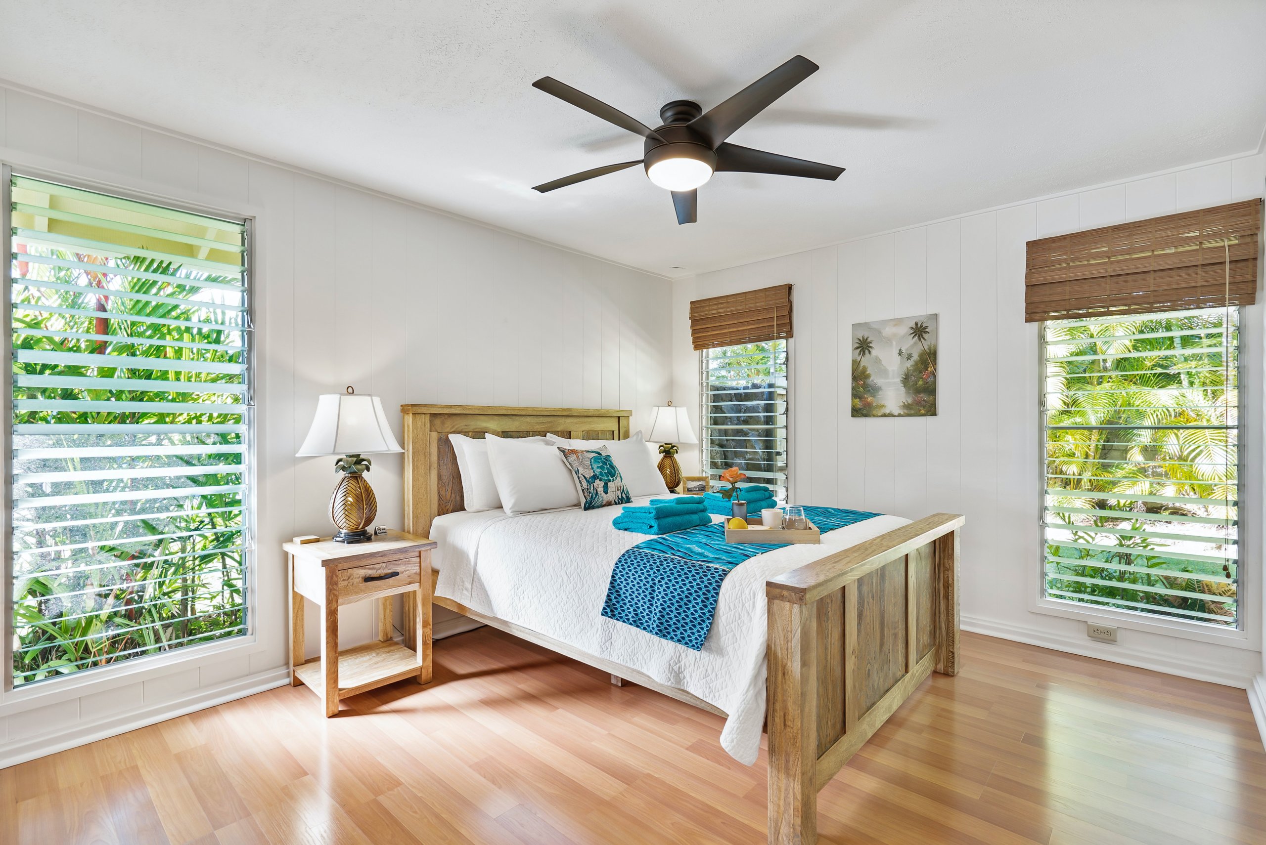 farmhouse style bedroom with shutters and bamboo window covering