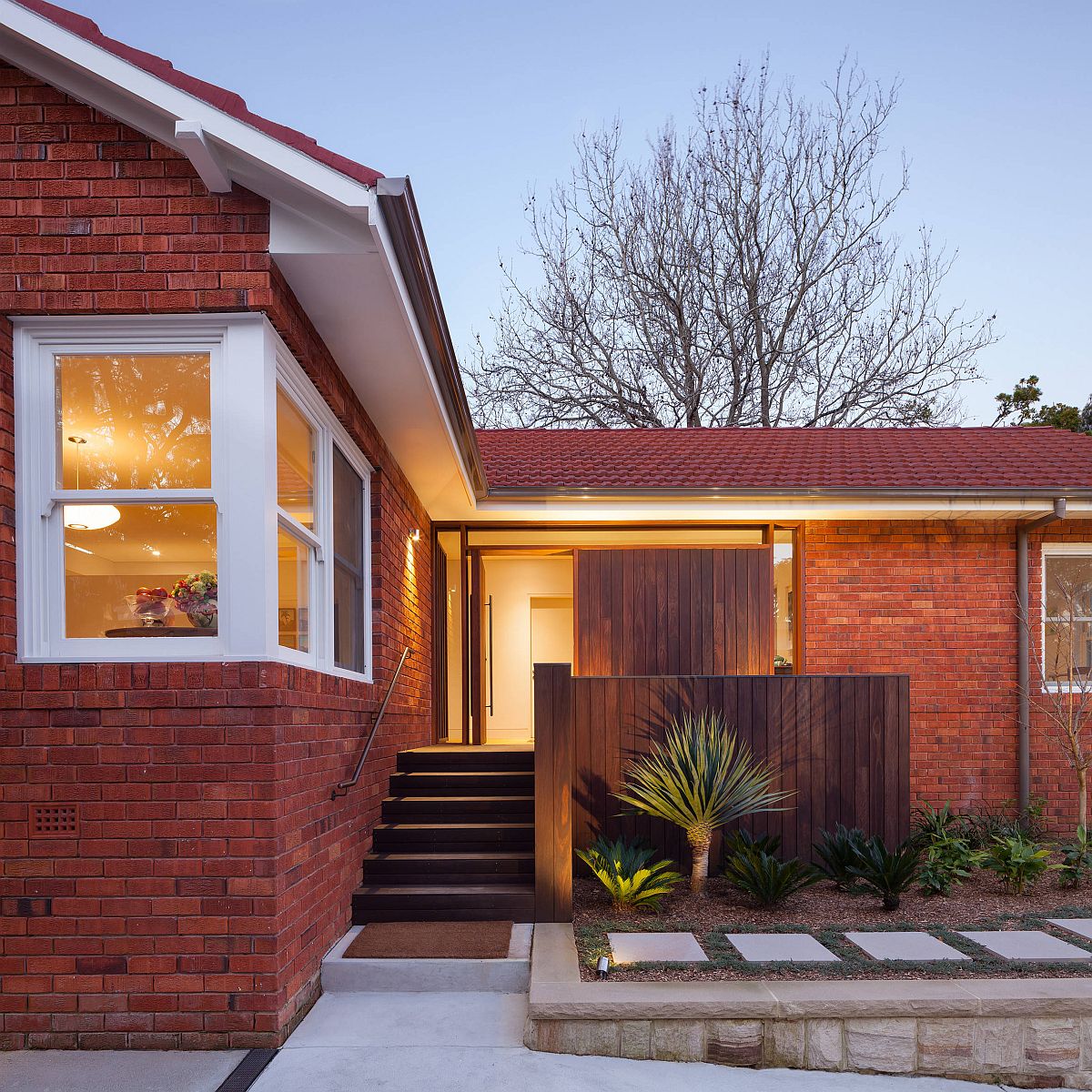 Classic brick walls give this home a comfortable redsheen while still keeping the facade modern