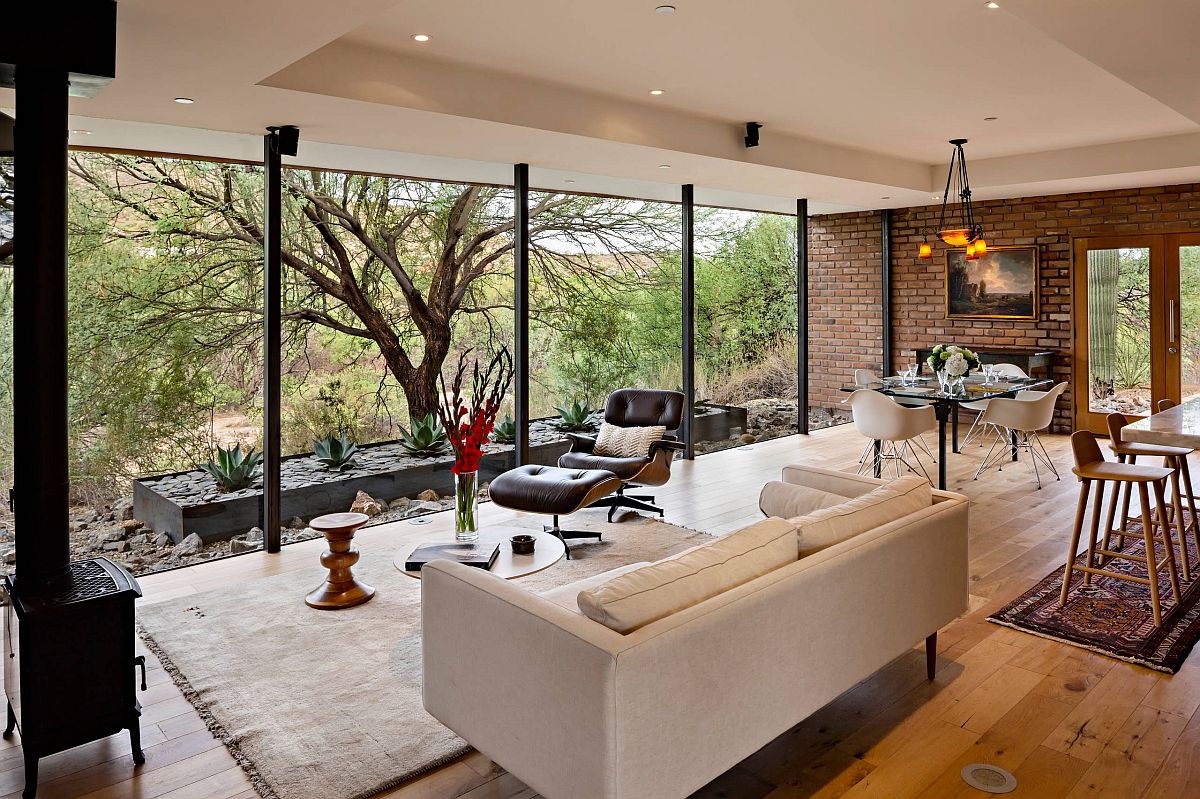 Fabulous series of floor-to-ceiling glass walls connects the interior with the outdoors