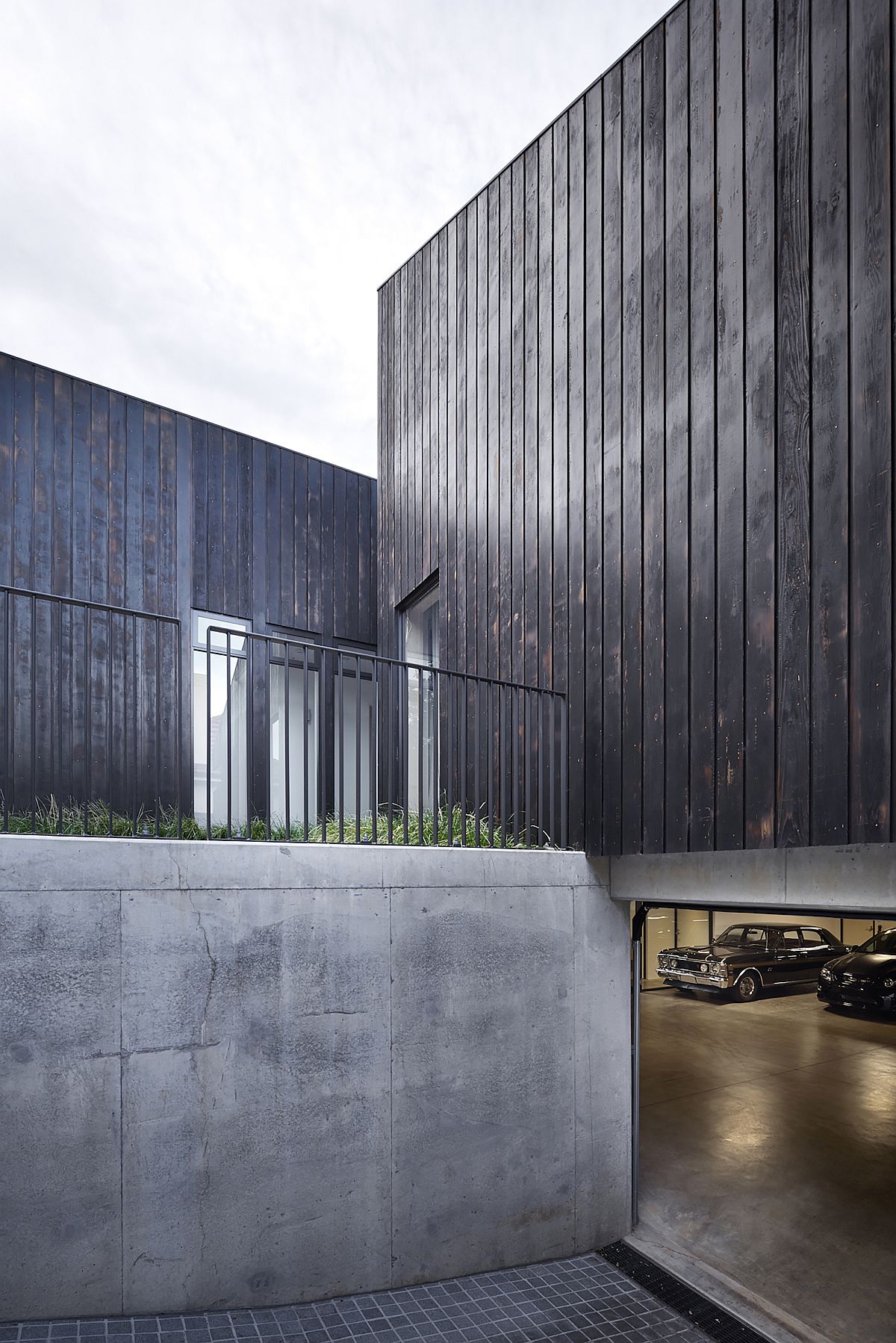 Hidden garage below the ground level of the house is stylish and minimal