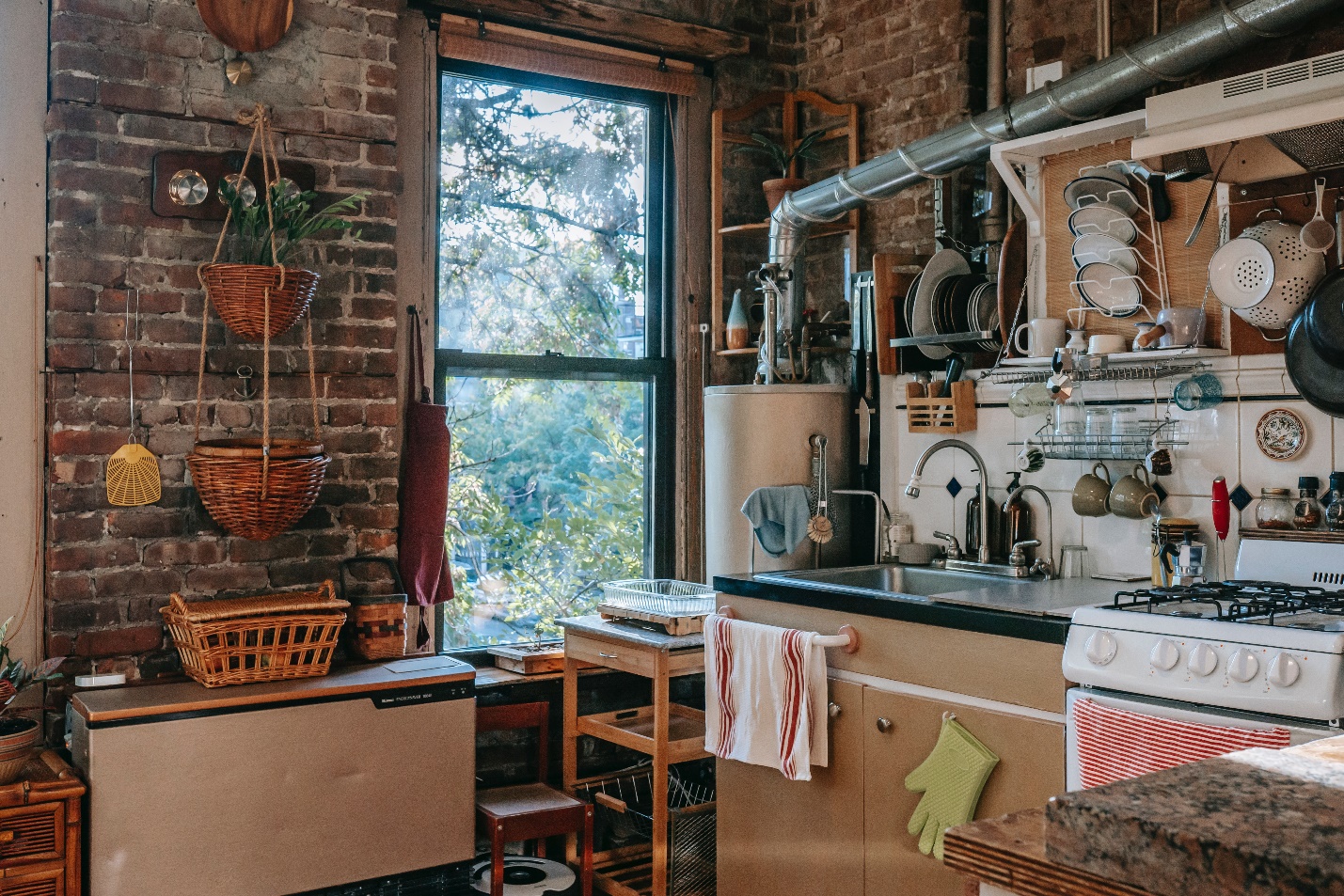 rustic overcrowded kitchen with brick wall