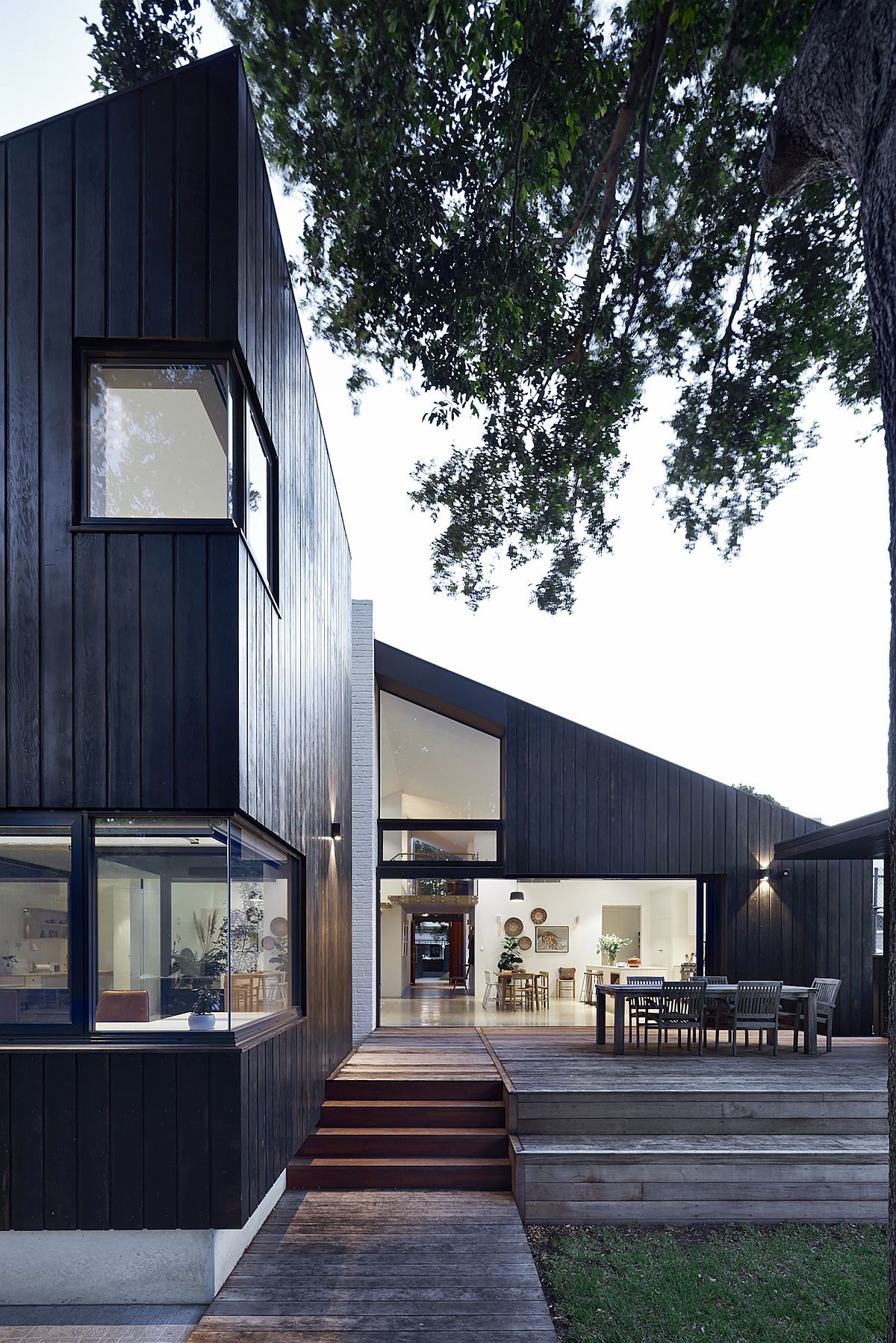 Large wooden deck extends the living area outdoors and connects the interior with the garden