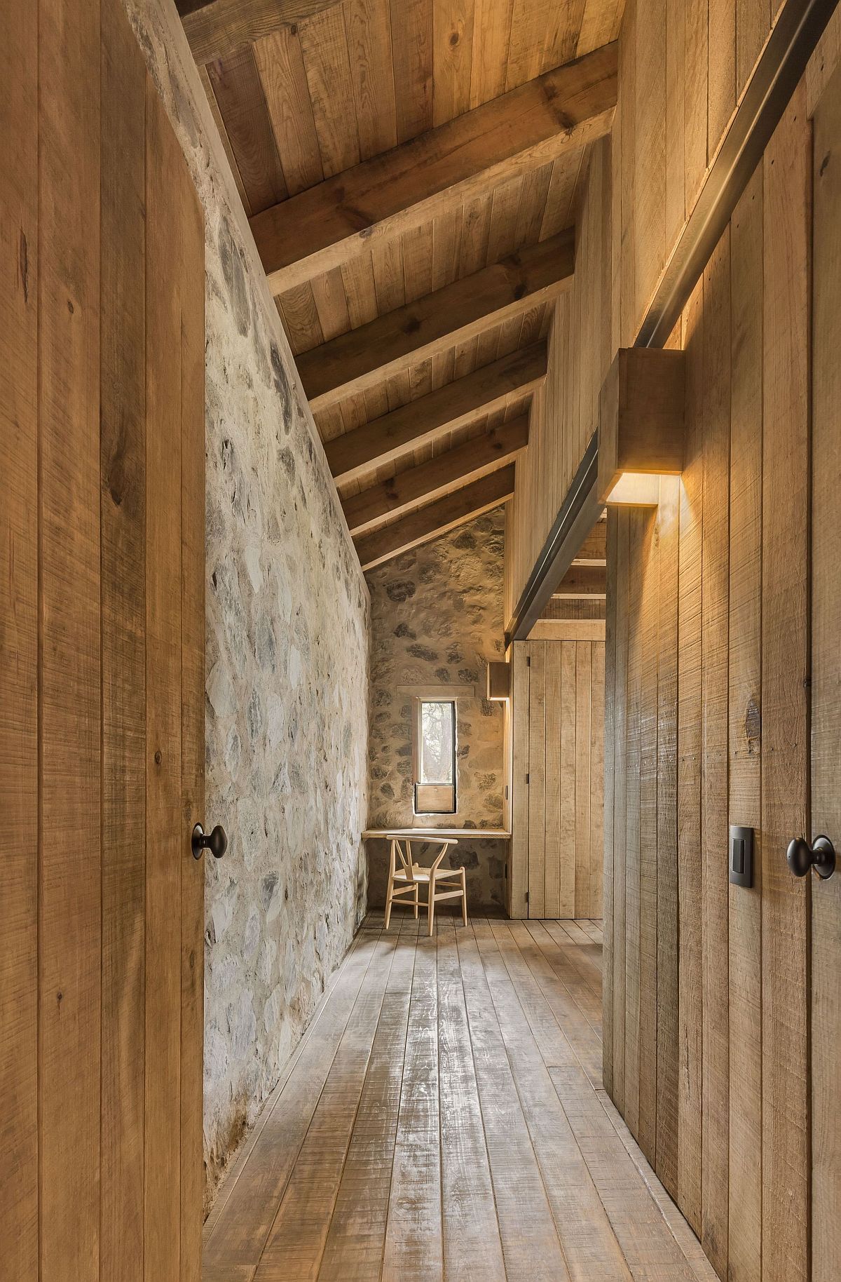 Long corridors inside the cabin with wooden walls and cabinets connecting various rooms