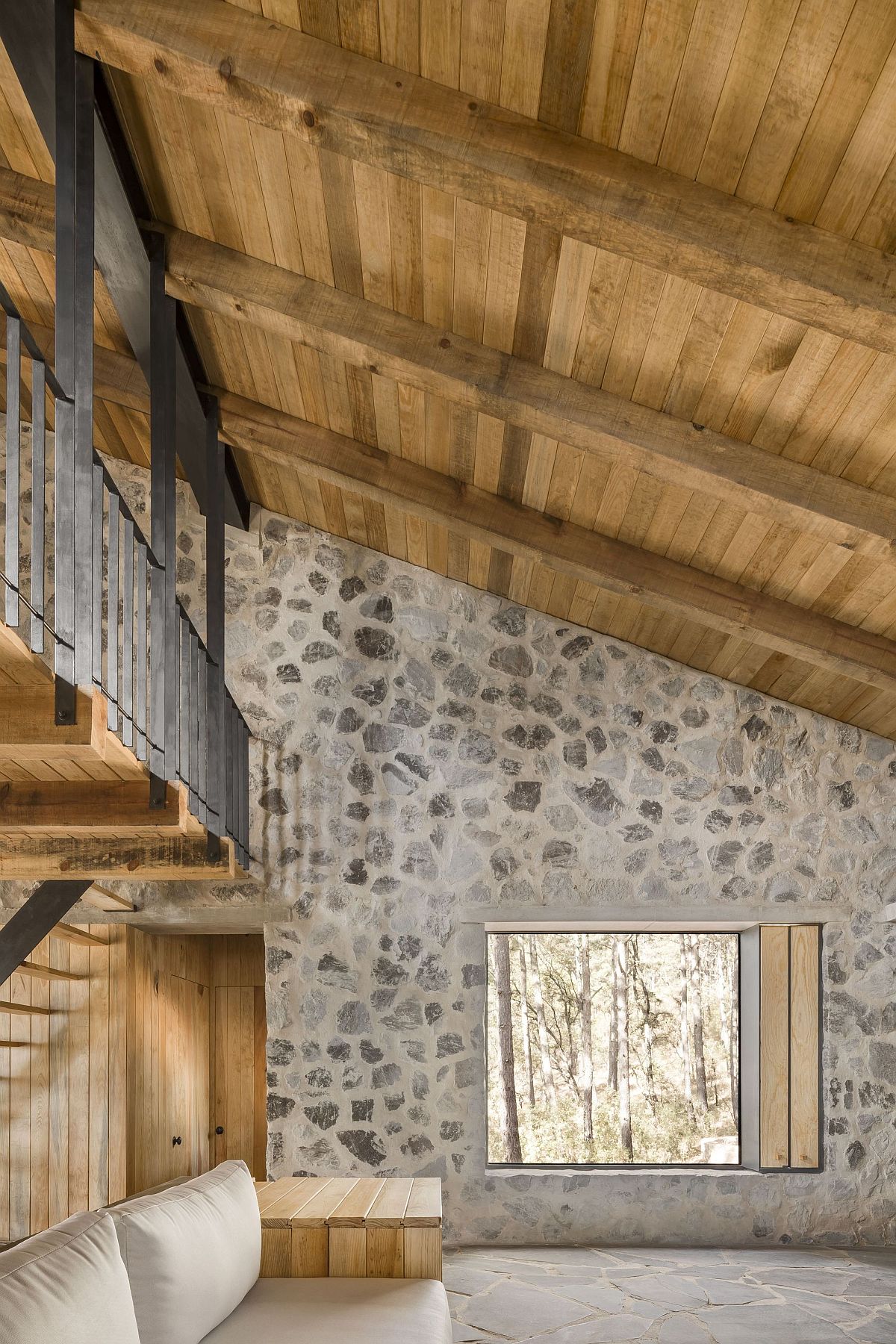 Look at the interior of the stone cabins with sloped wooden ceiling