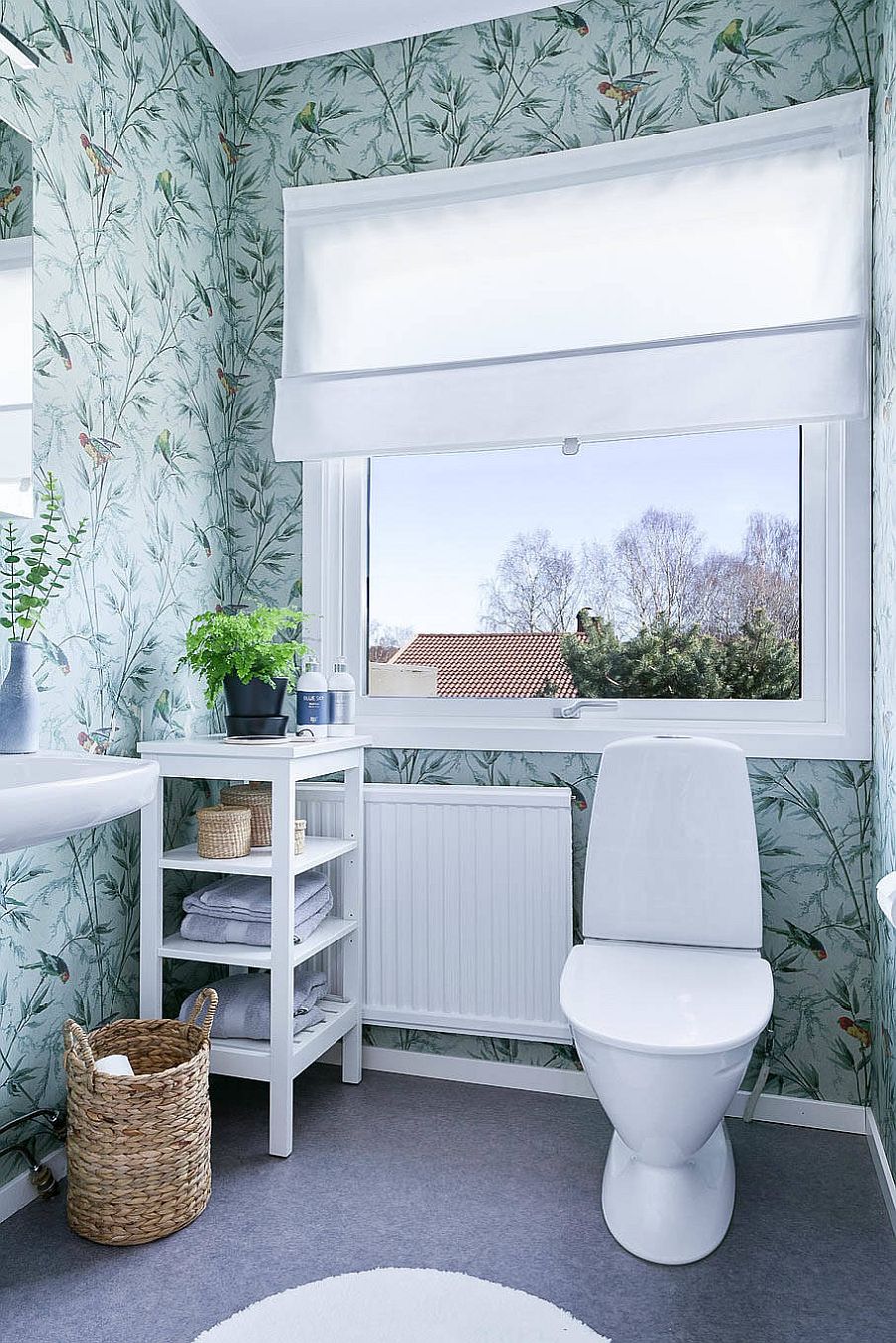 Modern Scandinavian style powder room with floral pattern wallpaper and light blue backdrop