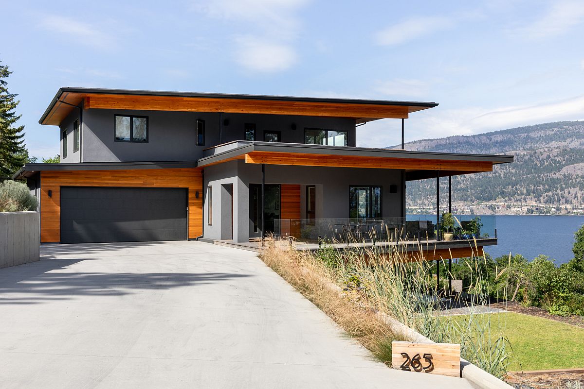 Mountain home with polished gray exterior that is accentuated by woodsy trims and shades