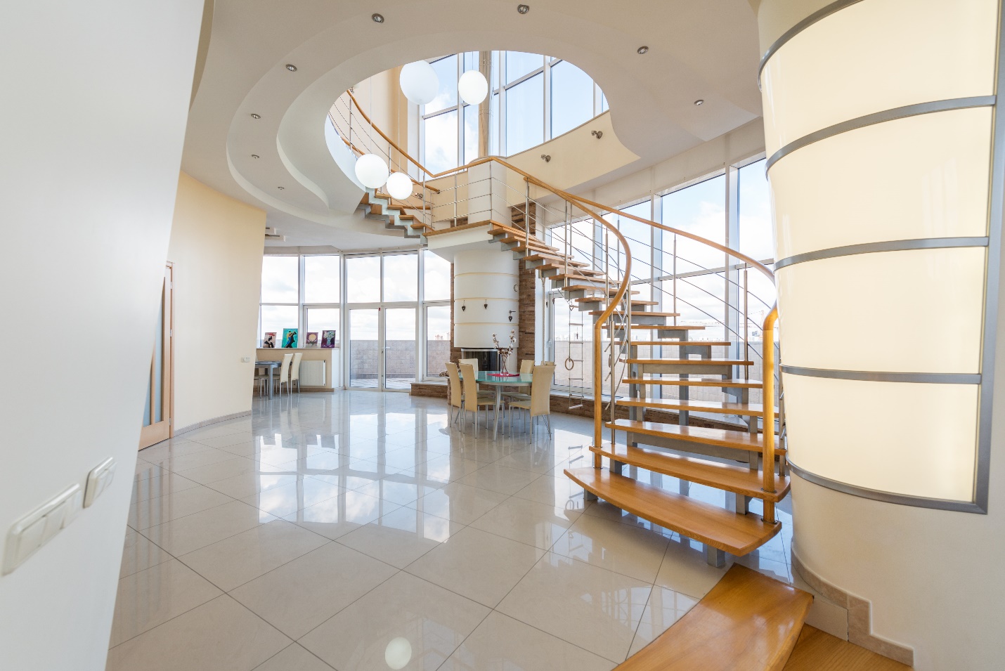 room with high ceiling and winding staircase