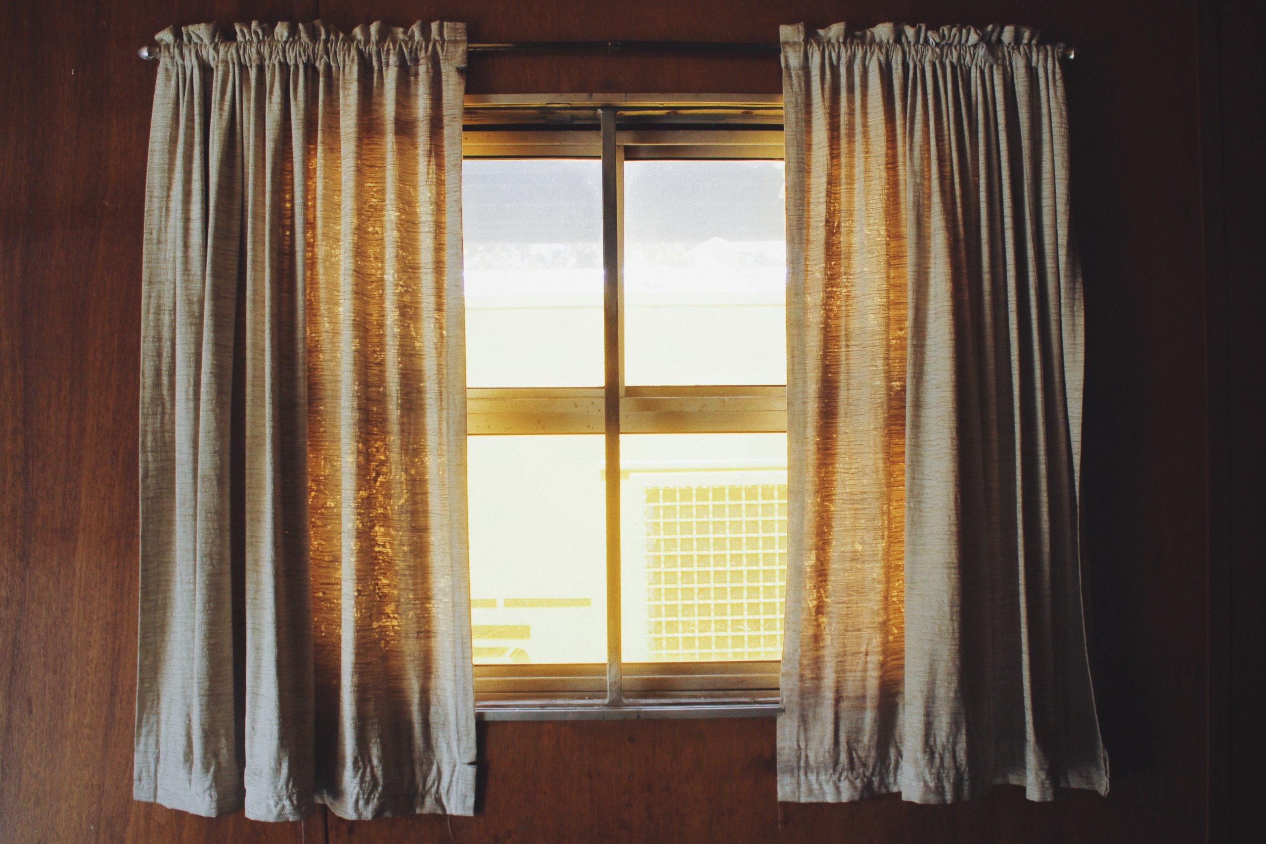 Sunlight in brown window with brown curtain