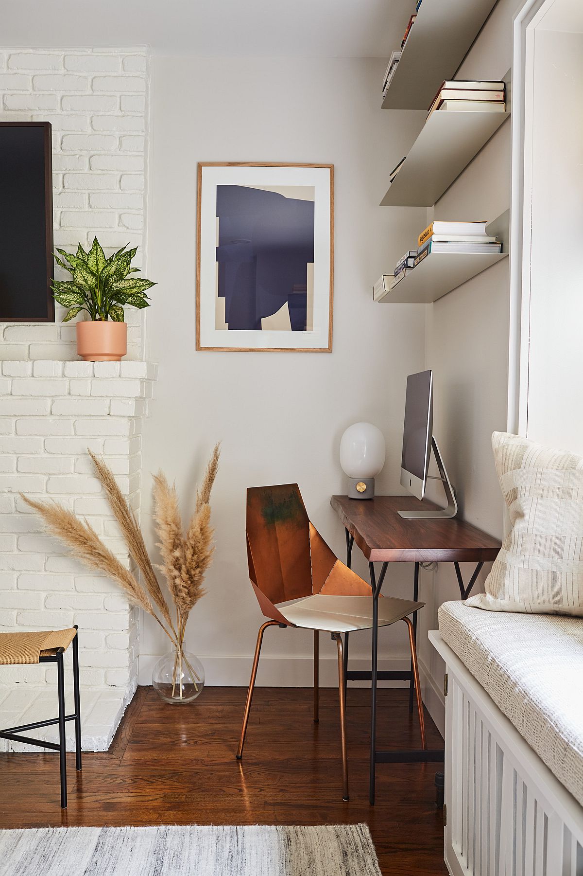 Three floating shelves and desk tiurn the corner into a cozy home workspace