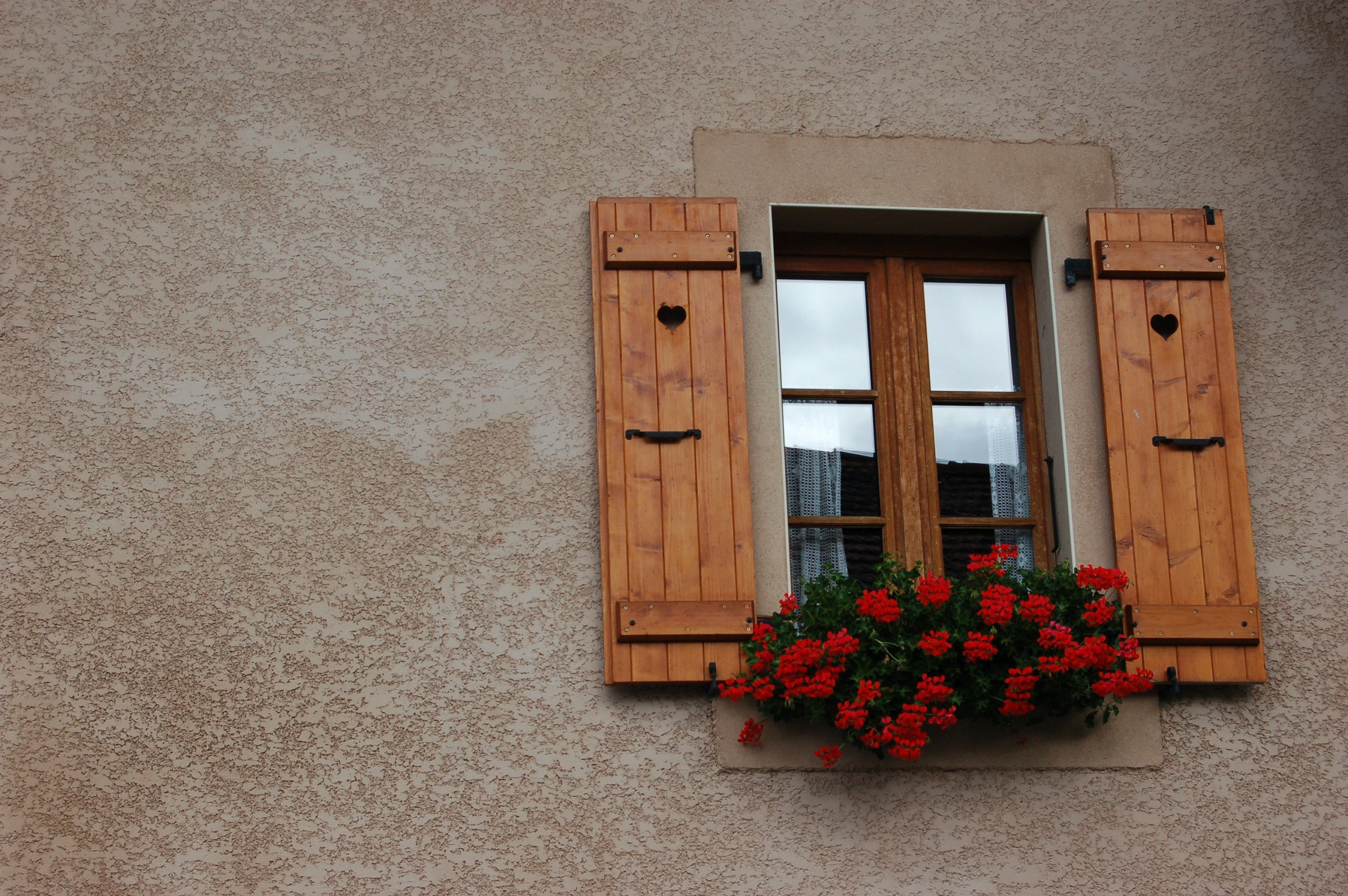 wooder shutter on outside of rustic home